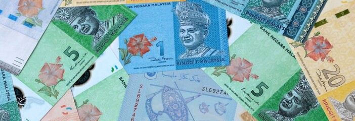 Malaysian ringgit money banknotes bunch on table. Malaysia bills of MYR currency © Larysa