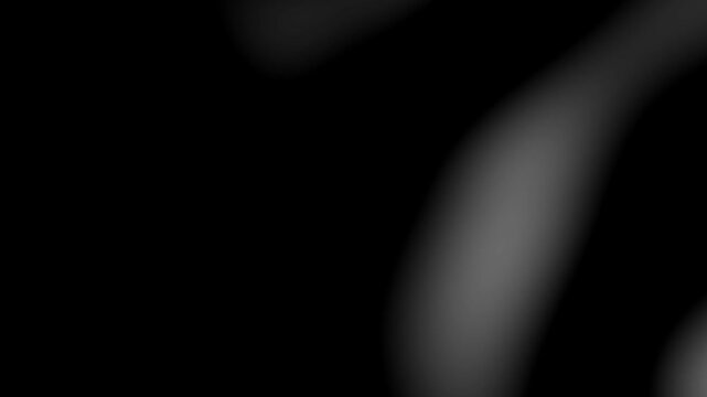 Abstract cinematic dark background loop with soft white light leaks, organic smoke glow effect, and minimal backdrop in 4K resolution.