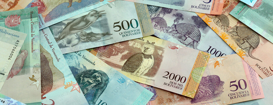 Venezuelan bolivar money banknotes pile on table. Venezuela bills of VES currency close up