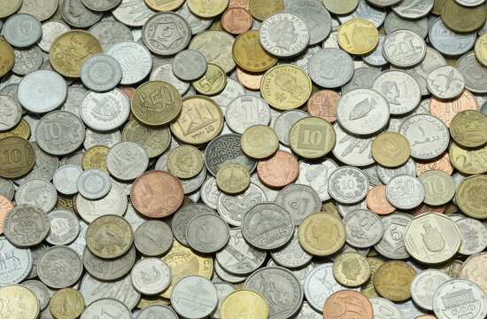 Close up shot of many coins, various denominations mixed in heap. Global money assortment