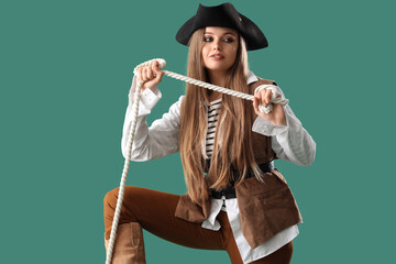 Adventure and exploration concept, young woman dressed as a pirate holding a rope for nautical travel and maritime fantasy themes on green background © Pixel-Shot