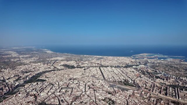 Left side cockpit window of Valencia city and seafront captured from a jet cockpit in a summer day, with a view of city center, Malvarrosa Beach and north coast. sunny summer day.