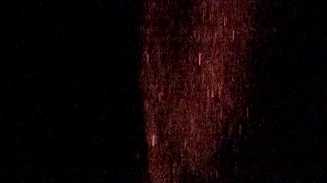 Scintillating golden particles stream downward.
