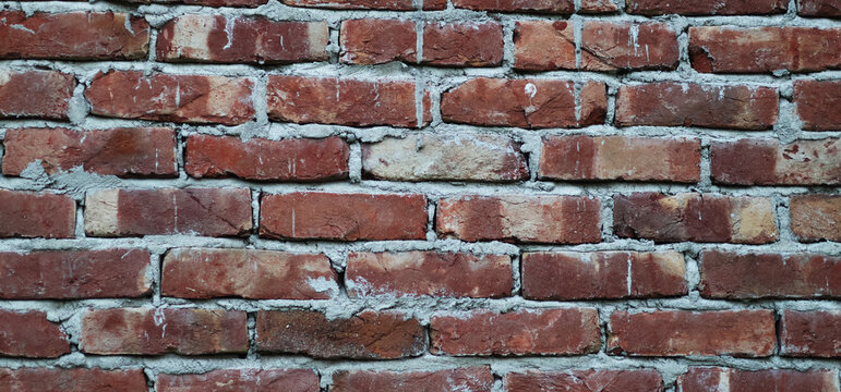 Red brick wall texture background with rustic weathered masonry