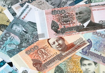 Cambodian riel money bills in pile on table. Cambodia KHR currency cash close up © Viktor