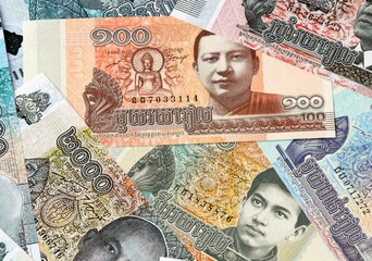 Cambodian riel money bills in pile on table. Cambodia KHR currency cash close up © Viktor