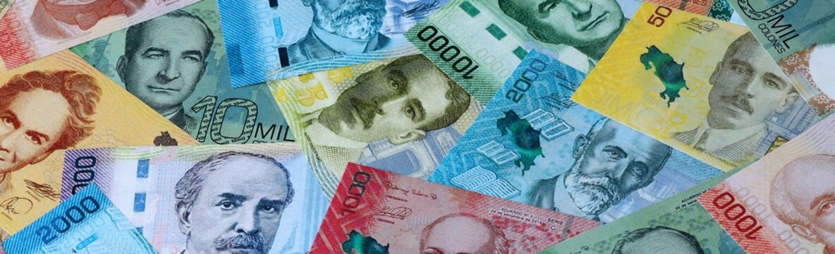 Costa Rican colon money bills in pile on table. Costa Rica CRC currency cash close up