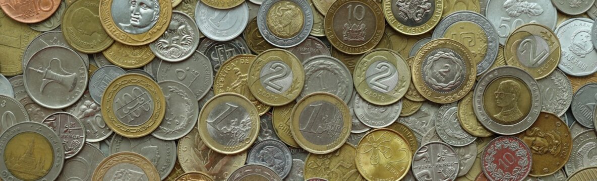 Big pile of coins from various money currencies. Treasure and numismatics concept