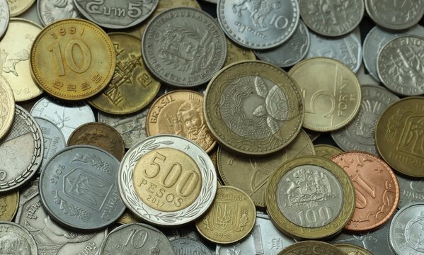 Big pile of coins from various money currencies. Treasure and numismatics concept