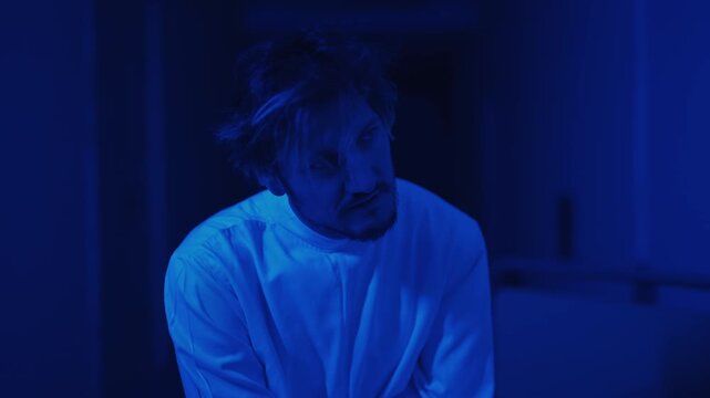 Man in a straitjacket in a padded room. Mental illness, psychiatric hospital and schizophrenia