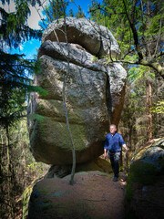Male hiker walking past the massive Sphinx granite rock formation on the Druid Trail in Waldviertel Austria © fotofrank