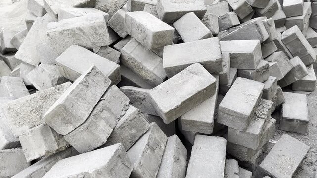 Pile of grey concrete bricks at industrial construction site