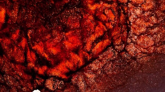 Mixing different colored alcohol inks to create vibrant patterns in