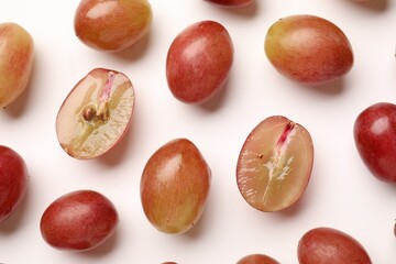 Fototapeta premium Fresh ripe grapes on white background, flat lay