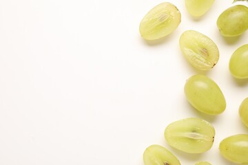 Fototapeta premium Fresh ripe grapes on white background, flat lay. Space for text