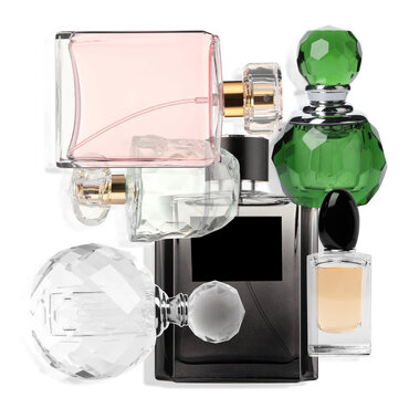 Bottles of different perfumes on white background, collage