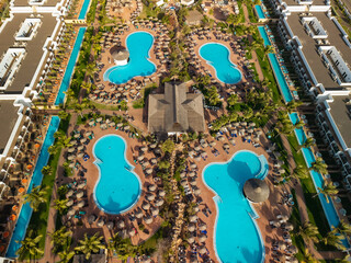 Naklejka premium Top down aerial view of swimming pools at luxury resort on Sal island Cape Verde