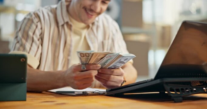 Counting, laptop and happy man with cash in office for small business management, profit or accounting. Male person, entrepreneur or finance with money for startup revenue or return on investment