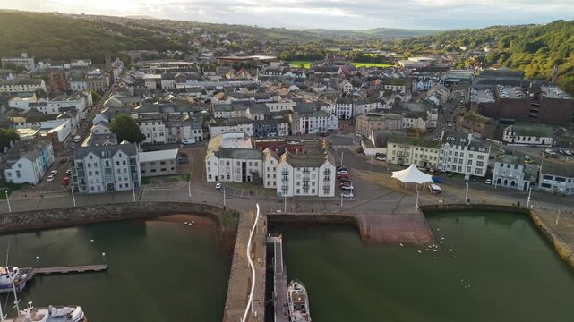Aerial panoramic views of Whitehaven coastal town and civil parish. Town centre with architecture and main roads with moving vehicles in Sunrise, golden hour. Drone POV exploration of Devon County, UK