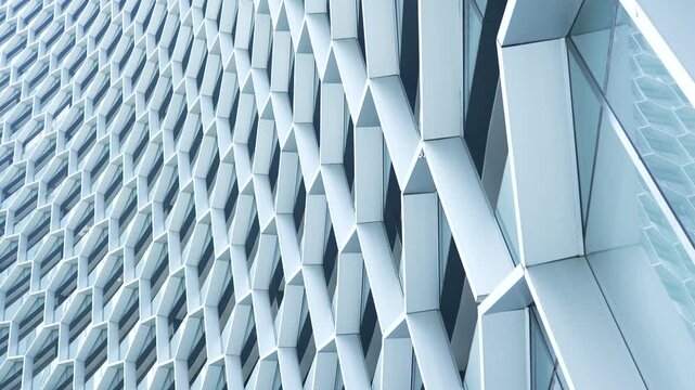 Perspective view of futuristic modern skyscraper facade built with intricate white hexagonal honeycomb grid panels.