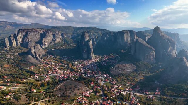 Establishing aerial view of the mountains of Meteora, Kalampaka, Greece, with the little village Kastraki and sunshine