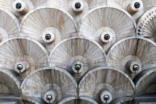 Fan shaped travertine stone pattern with cylindrical drainage spouts covering the facade of the Cascade complex in a symmetrical repeating design, Yerevan, Armenia