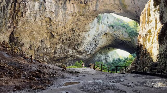 Devetashka cave interior view massive karst arches natural skylight bridge Devetaki Lovech Bulgaria travel tourism destination concept horizontal video stock footage