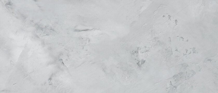 Pale gray concrete surface with uneven trowel strokes and scuffed patches forming a rough background
