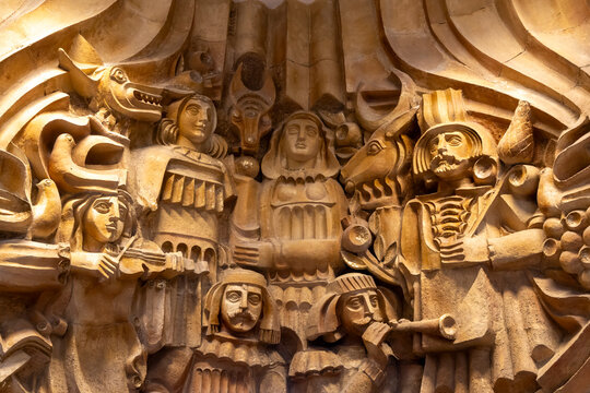 Carved stone sculptural relief of Armenian figures musicians playing violin and animals including a wolf and goat decorating the Moscow Cinema hall, Yerevan, Armenia