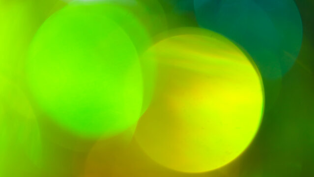 Abstract blurred bokeh background with soft lime green and yellow circles