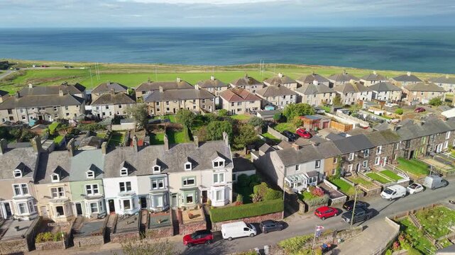 Aerial panoramic views of Whitehaven coastal town and civil parish. Demonstration of old Town architecture with roads and moving vehicles. Drone POV exploration of Devon County, England, UK.