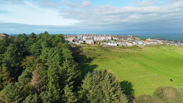 Aerial panoramic views of Whitehaven coastal town and civil parish. Demonstration of old Town architecture with roads and moving vehicles. Drone POV exploration of Devon County, England, UK.