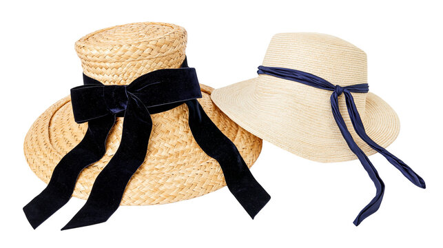 Isolated elegant straw hats with black velvet and navy blue ribbons, stylish summer fashion accessories