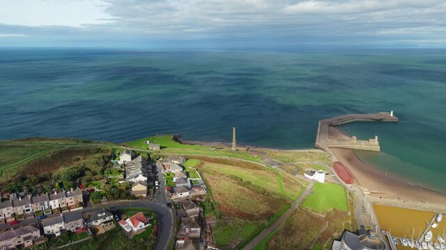 Aerial panoramic views of Whitehaven coastal town and civil parish. Demonstration of old Town architecture with roads and moving vehicles. Drone POV exploration of Devon County, England, UK.