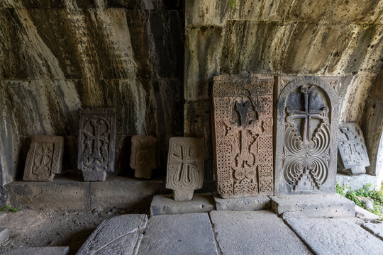 Carved khachkar stone crosses bearing ornamental patterns stand on display in the outdoor grounds of the medieval Haghpat Monastery a Christian heritage site, Haghpat, Armenia