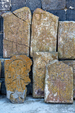 Khachkar stone crosses displaying intricate ornamental carvings and ancient religious patterns weathered with moss at the historic Sevanavank Monastery, Sevanavank, Armenia