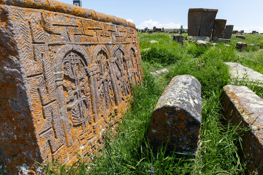 Close up of an intricate carved khachkar pattern showing an Armenian cross and relief carving at the ancient medieval cemetery in Gegharkunik Province, Noratus, Armenia