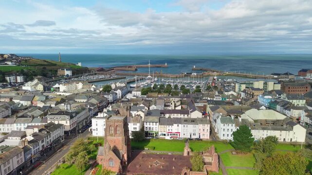 Aerial panoramic views of Whitehaven coastal town and civil parish. Demonstration of old Town architecture with roads and moving vehicles. Drone POV exploration of Devon County, England, UK.