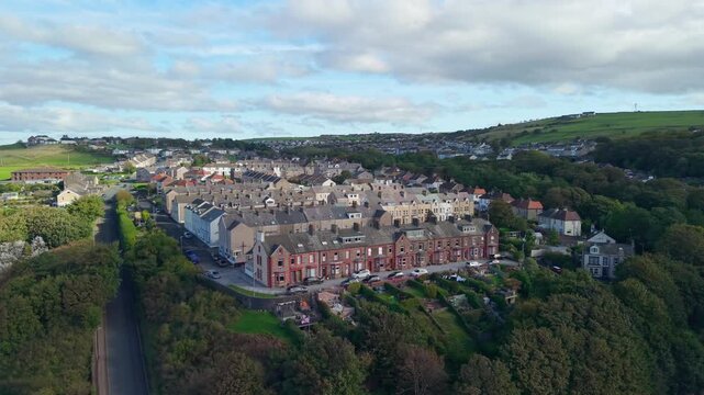 Aerial panoramic views of Whitehaven coastal town and civil parish. Demonstration of old Town architecture with roads and moving vehicles. Drone POV exploration of Devon County, England, UK.