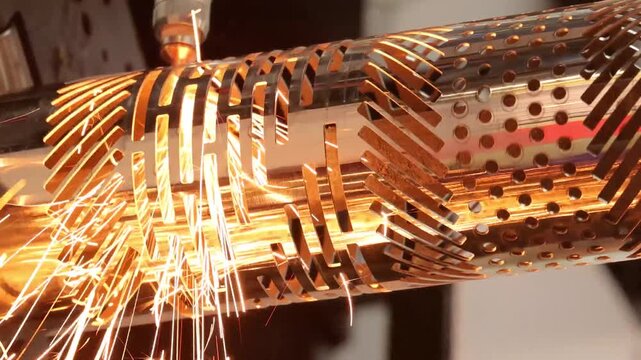 Close up of metal pipe being cut with laser sparks flying with a dynamic industrial process.