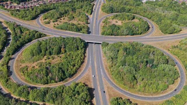 Aerial View of a Busy Cloverleaf Interchange in Lush Greenery