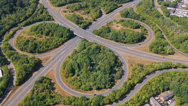 Aerial View of Cars Driving Along a Large Cloverleaf Highway
