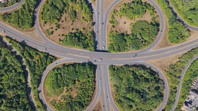 Aerial View of Busy Highway Cloverleaf With Cars