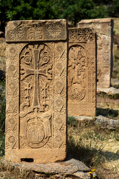 A narrow carved stone window shaft inside the tower of Surb Astvatsatsin church lets a thin shaft of light fall across the dark passage and ancient inscriptions, Noravank, Armenia