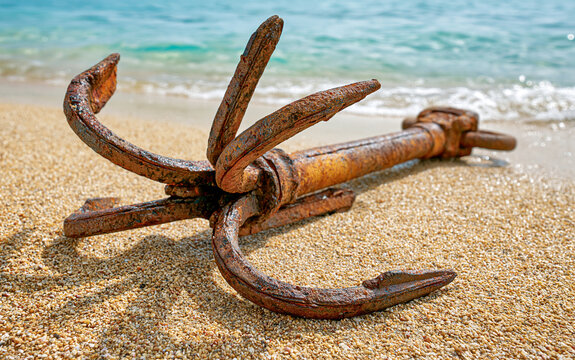 Classic Multi-Pronged Grapnel Anchor on Sparkling Golden Sand