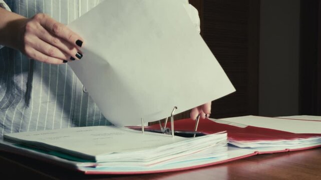 Female Employee Organizing Paperwork in Corporate Archive