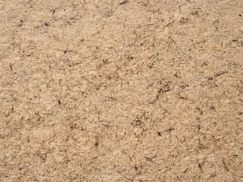 Macro texture of brown pressed cardboard or particle board surface