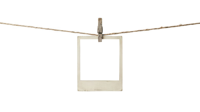 Blank vintage polaroid photo hanging on rope isolated on transparent background