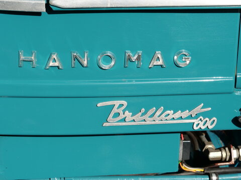 Germany, H&ouml;velhof, October 03. 2026, Original chrome-plated model lettering for a Hanomag Brillant 600 on the blue-green hood of a vintage tractor