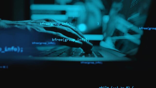 Lines of code on a cyan screen with a hand at the keyboard. Software development, scripting and IT work